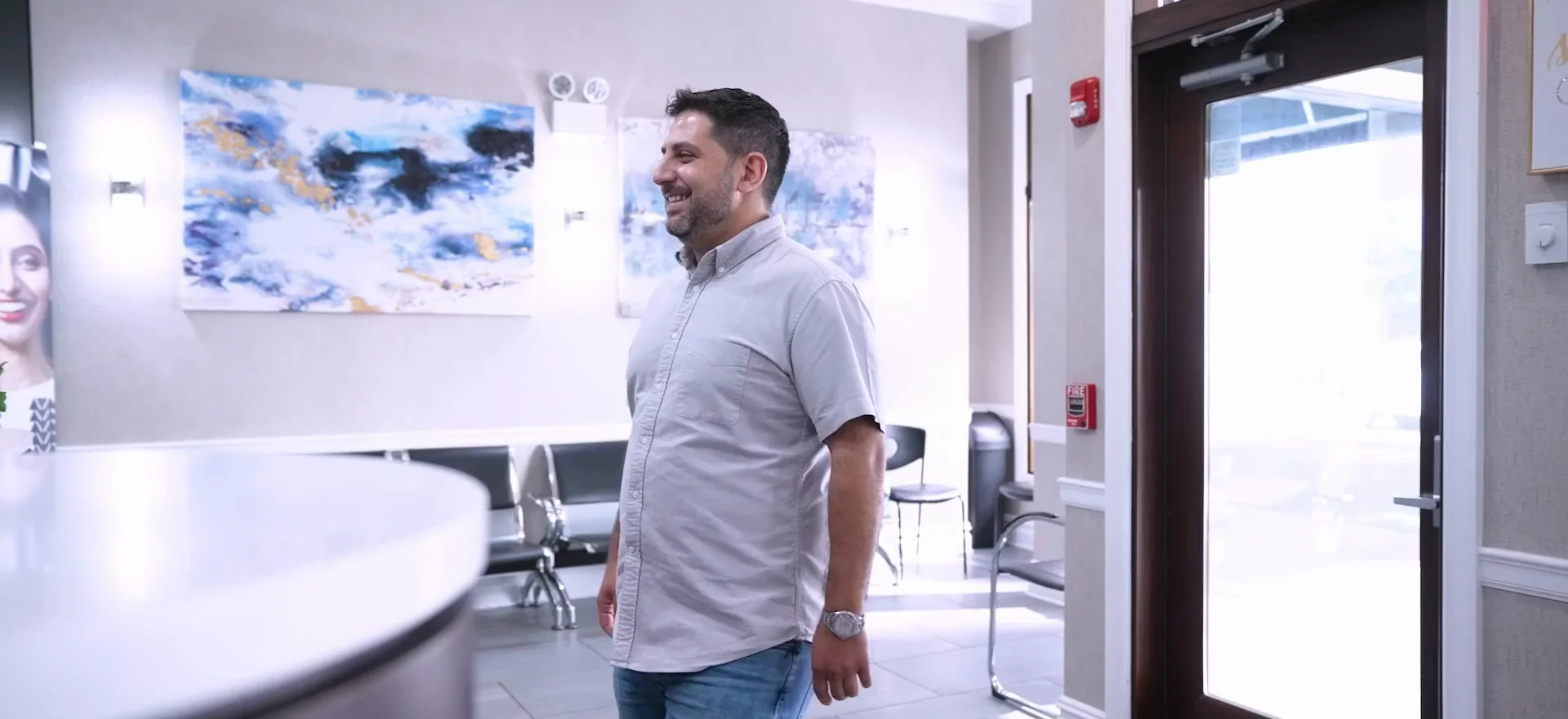 A patient walking into the reception of the practice