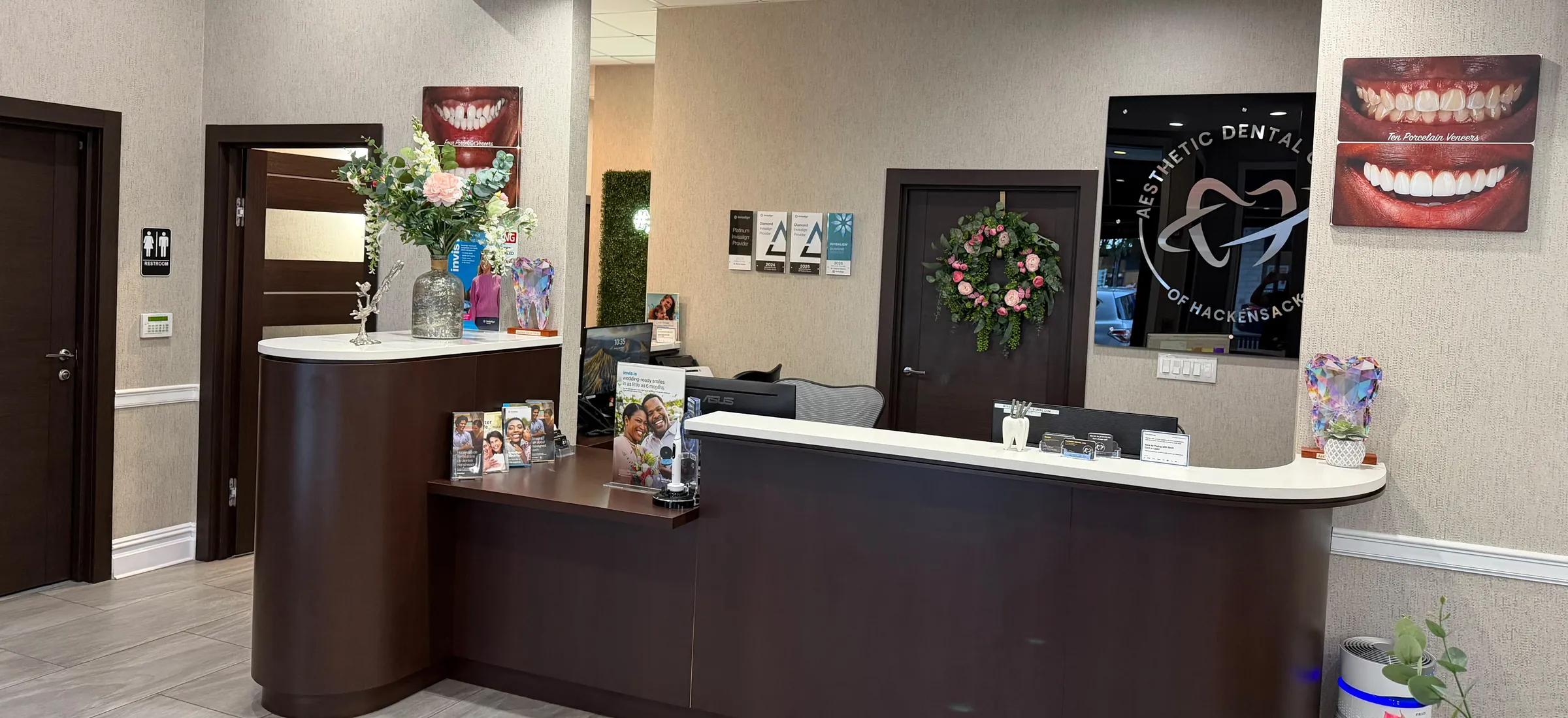 The curved reception desk of the practice under a round ceiling light