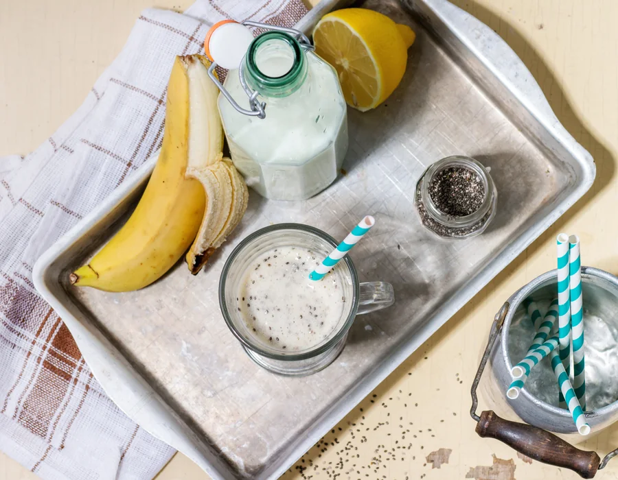 A tray of soft foods and drinks: a banana, a smoothie and milk