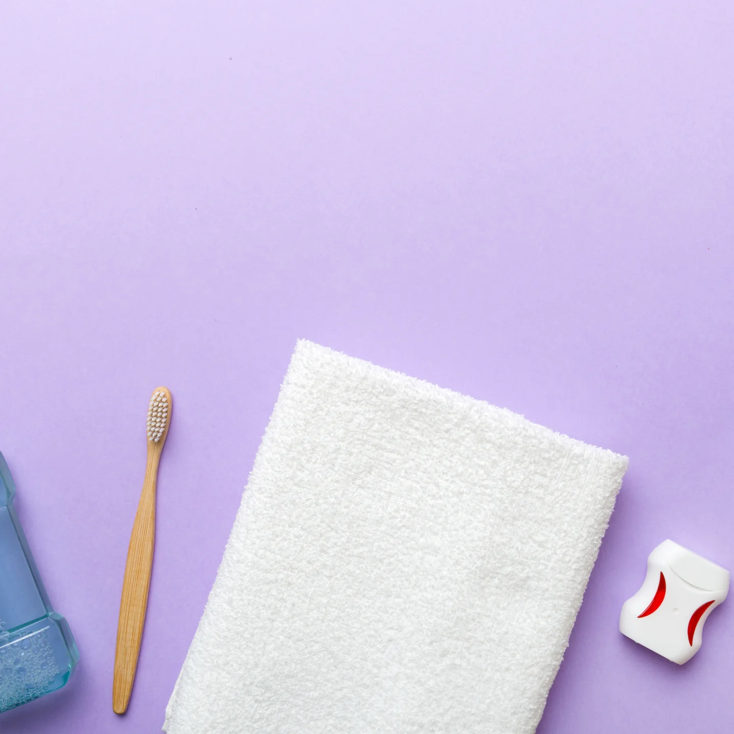 Mouthwash, a towel, a bamboo toothbrush and floss